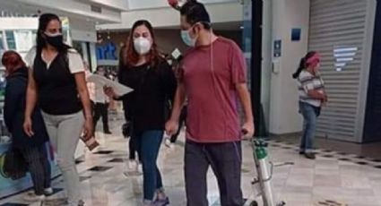 FOTO: Indigna la imagen de un hombre paseando en un centro comercial con tanque de oxígeno