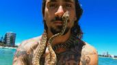 Multan a surfista por maltrato animal; 'saltó' al mar acompañado de una serpiente